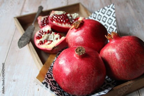 pomegranates on wood and an old and opened grenade knife
