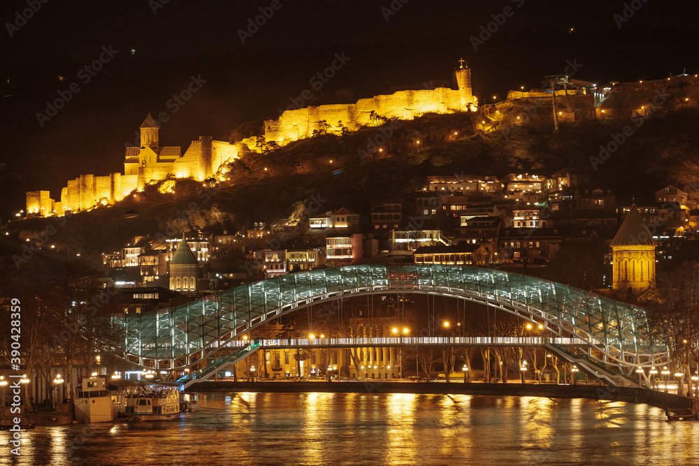 beautiful view of night tbilisi. the old city and the bridge of the world in the night lights.