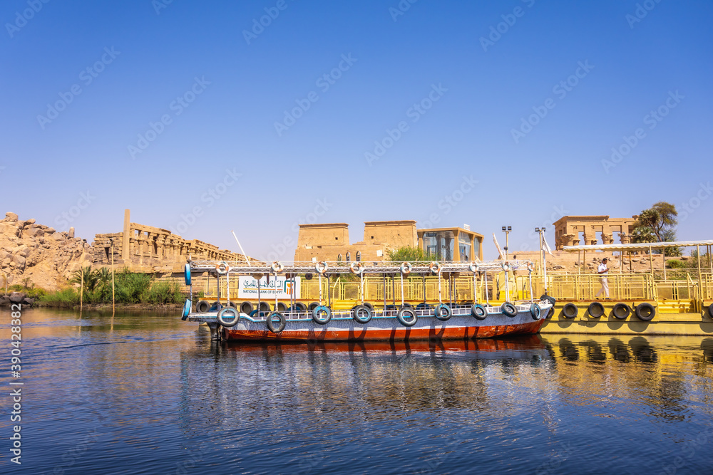 Traditional transport boats to the temple of Philae, a Greco-Roman construction seen from the Nile river, a temple dedicated to Isis, goddess of love. Aswan. Egyptian