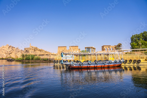 Traditional transport boats to the temple of Philae, a Greco-Roman construction seen from the Nile river, a temple dedicated to Isis, goddess of love. Aswan. Egyptian