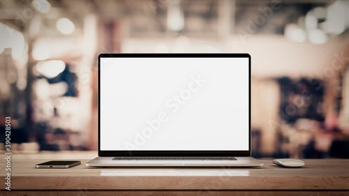 Laptop with blank screen on table smooth zoom in with mouse and smartphone. factory or loft background, 4k 30fps UHD