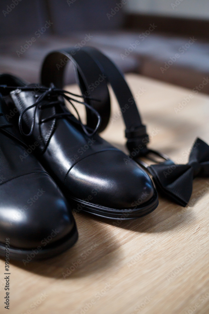 Morning details of a stylish groom with leather shoes Morning details of a stylish groom with leather shoes