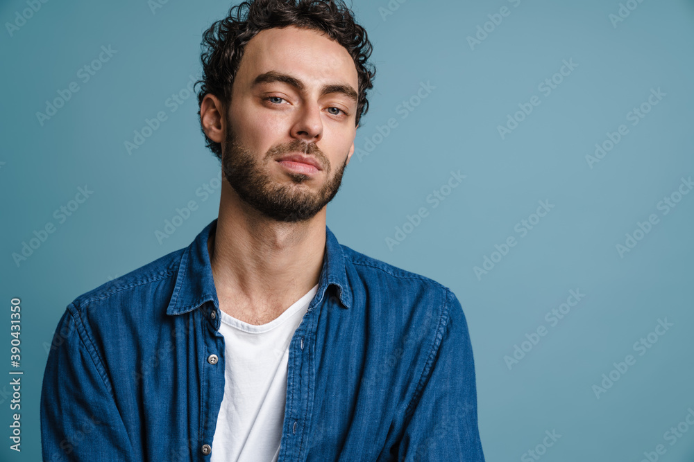 Unshaven handsome guy posing and looking at camera Unshaven handsome guy posing and looking at camera