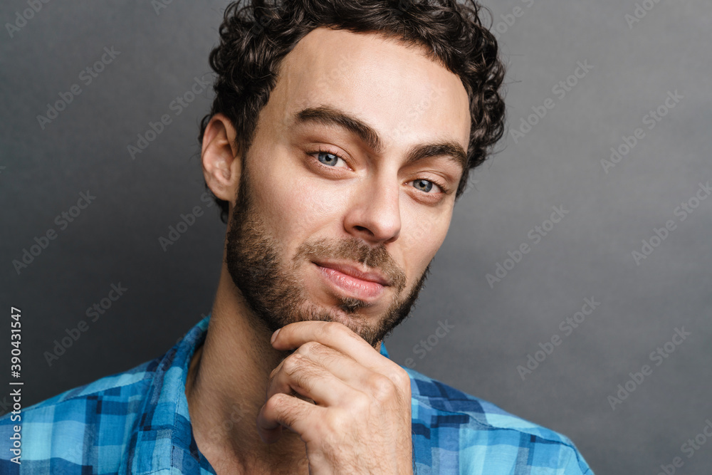 Unshaven pleased guy posing and looking at camera Unshaven pleased guy posing and looking at camera