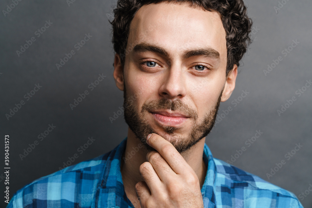 Fototapeta premium Unshaven pleased guy posing and looking at camera