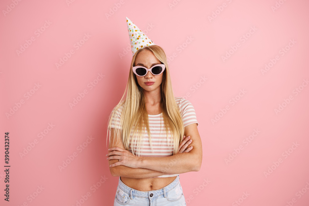Caucasian beautiful girl in party cone posing with arms crossed - obrazy, fototapety, plakaty 