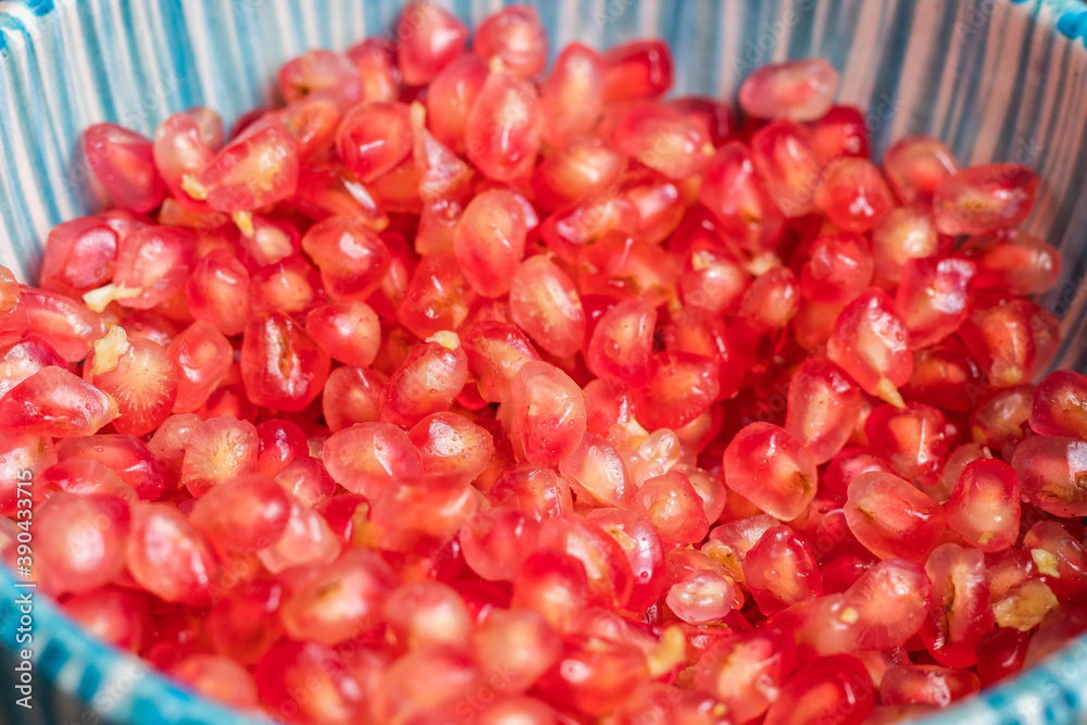 Pomegranate seeds in a blue bowl Pomegranate seeds in a blue bowl