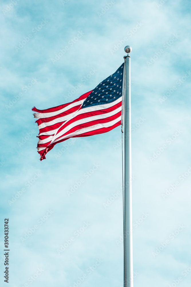 Lone American Flag in a Blue, Cloudy Sky