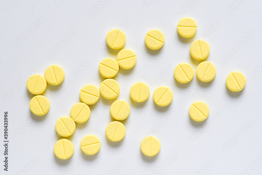 Yellow pill tablets on white background Yellow pill tablets on white background