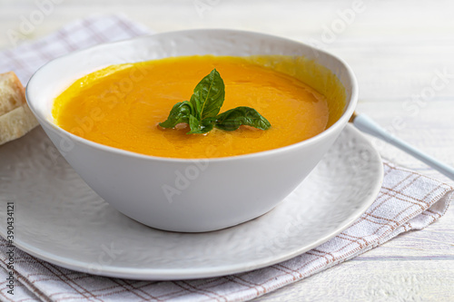 Fresh pumpkin cream soup with sour cream. Autumn lunch concept. A dietary, healthy dish.