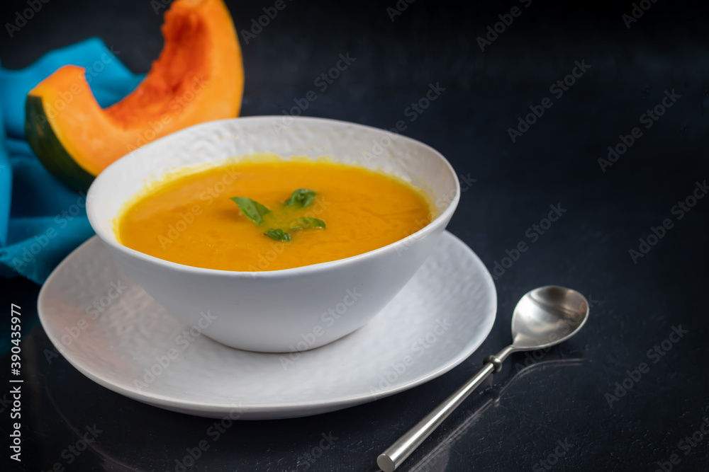 Fresh pumpkin cream soup with sour cream. Autumn lunch concept. On a wooden background. A dietary, healthy dish. Fresh pumpkin cream soup with sour cream. Autumn lunch concept. On a wooden background. A dietary, healthy dish.