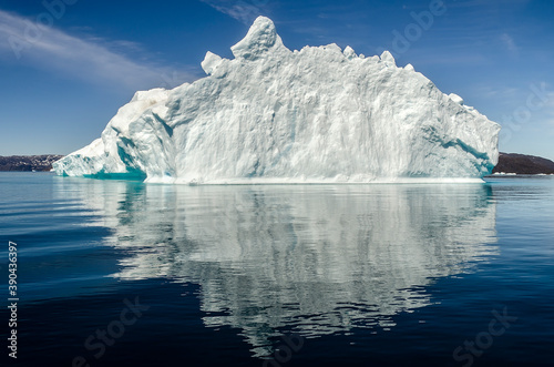 Bow of a dingy sailing among icebergs