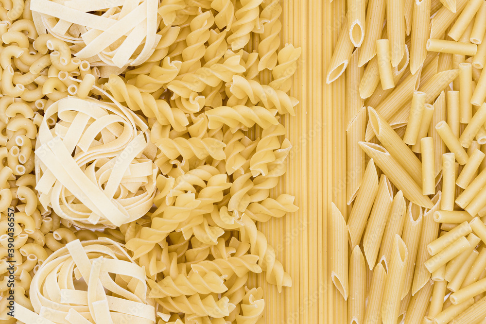 Selection of different pasta types on a white background. Healthy organic flat lay