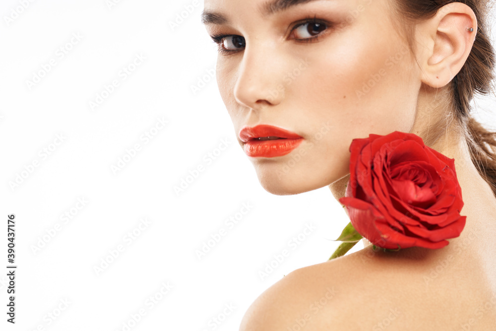 Portrait of woman with red rose naked shoulders Make-up on brunette face Portrait of woman with red rose naked shoulders Make-up on brunette face