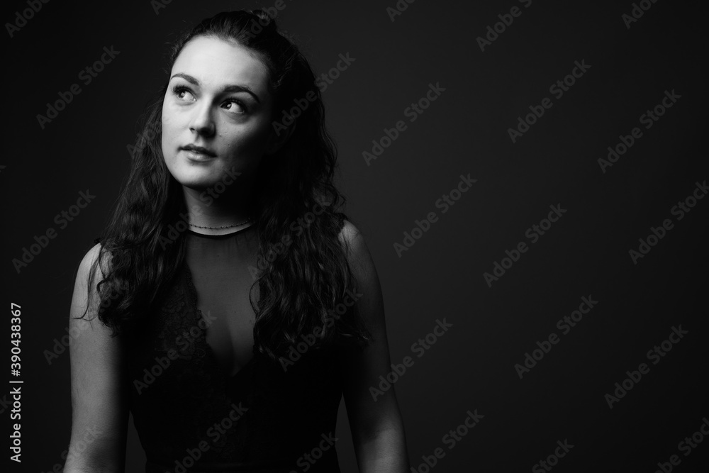 Studio shot of young beautiful woman against gray background Studio shot of young beautiful woman against gray background