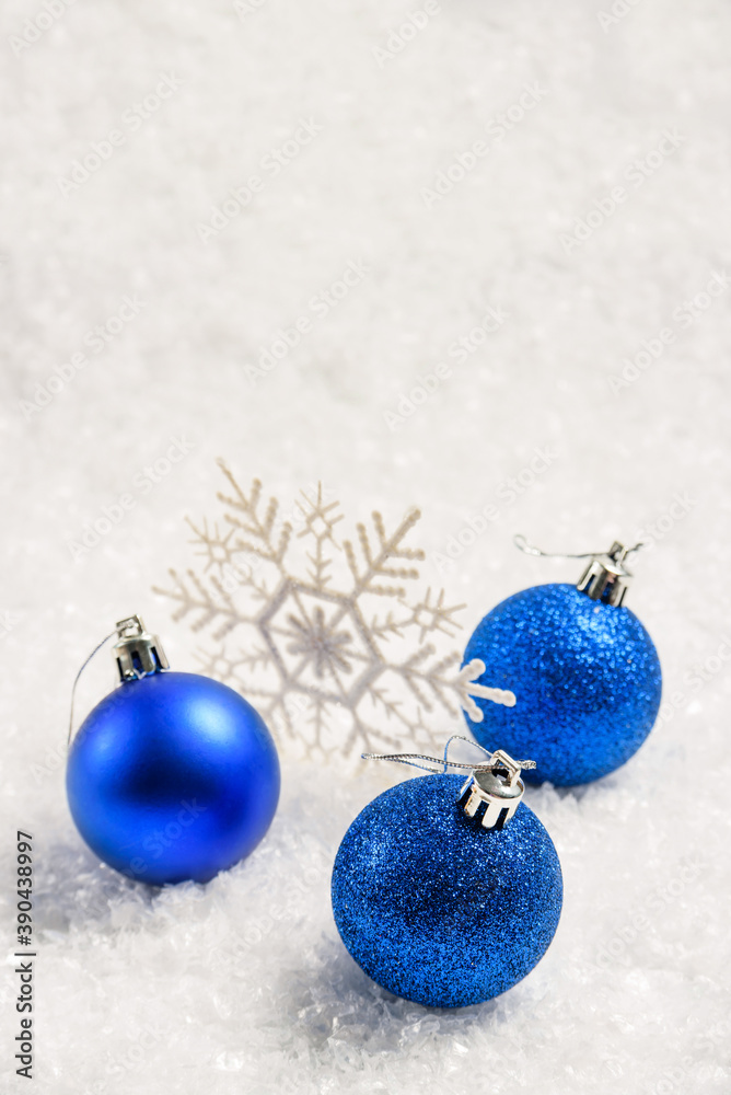Blue Christmas balls and snowflake in the snow with copy space and selective focus. Blue Christmas balls and snowflake in the snow with copy space and selective focus.