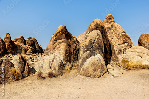 Rocky desert landscape with smooth boulders under a blue sky