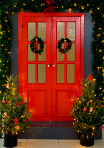 red doors with Christmas wreath and Christmas trees