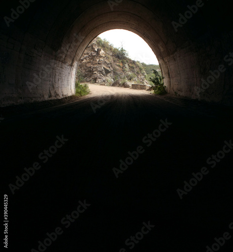 Transportation. Traveling along the dirt road high in the mountains. View of the highway from inside the Taninga tunnels in Cordoba, Argentina.  photo
