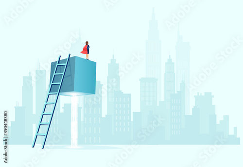 Vector of a super business woman with red cape standing on the top of a suspended cube looking at a cityscape