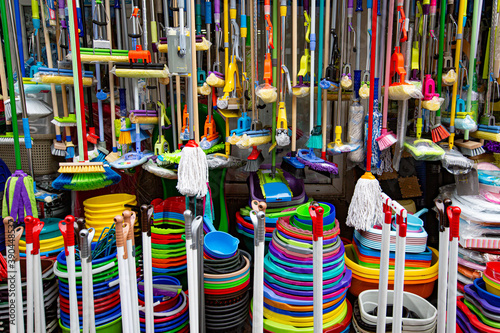 many home cleaning products. mops, brushes, buckets and scoops with brooms