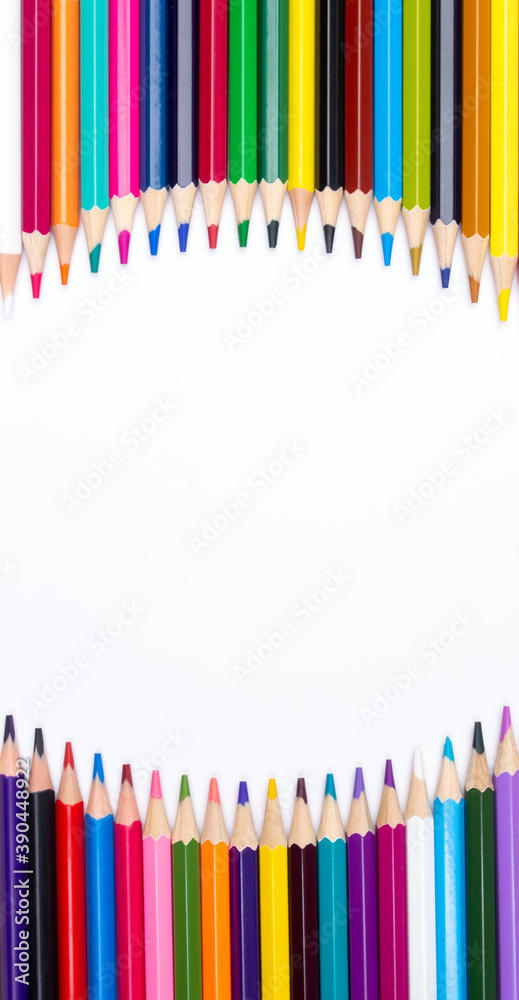 Color pencils on white background, top view with space for text or creativity. Color pencils on white background, top view with space for text or creativity.