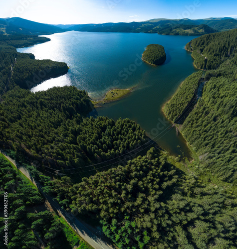 Aerial drone panorama of Vidra Lake. A lake located into the wild fir forests pf Lotru Mountains, Carpathia, Romania.