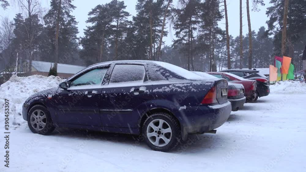 Auto on a parking. Winter, snowstorm.