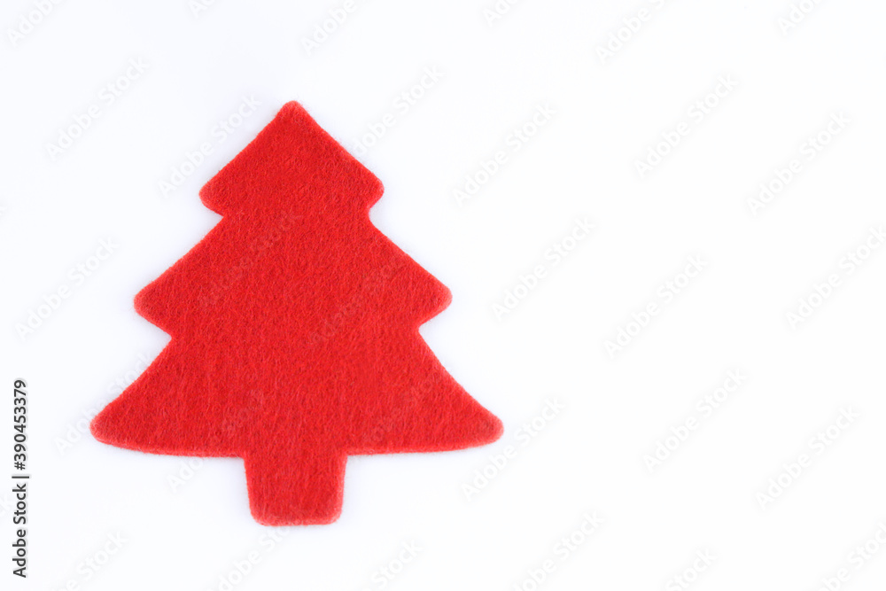 Red felt cut into a Christmas tree shape against white background with copy space Red felt cut into a Christmas tree shape against white background with copy space