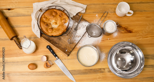 Photography Tasty apple pie on a oaken wood table with a ingredients