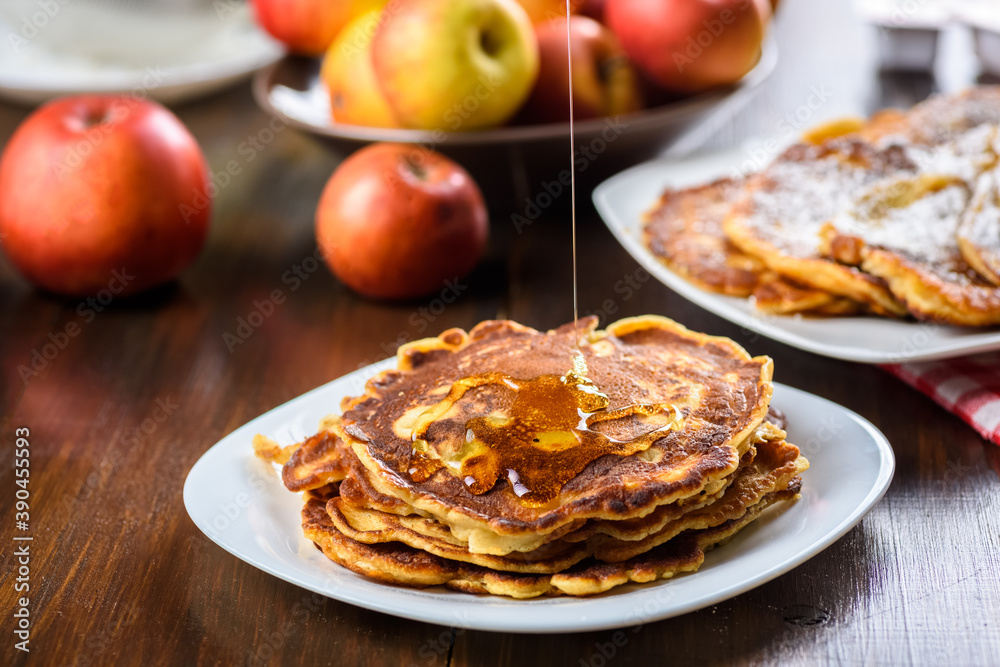homemade pancakes with apples poured with honey. homemade pancakes with apples poured with honey.