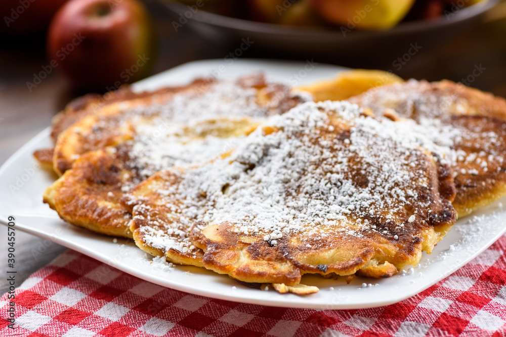homemade apple pancakes sprinkled with powdered sugar. homemade apple pancakes sprinkled with powdered sugar.