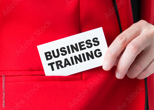 The businessman puts himself in her pocket a business card with the text BUSINESS TRAINING.