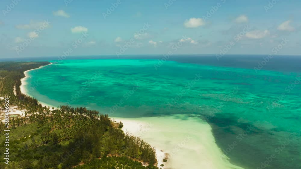 Tropical island with sandy beach by atoll with coral reef and blue sea, aerial view. Bugsuk Island with sandy beach. Summer and travel vacation concept. Tropical island with sandy beach by atoll with coral reef and blue sea, aerial view. Bugsuk Island with sandy beach. Summer and travel vacation concept.