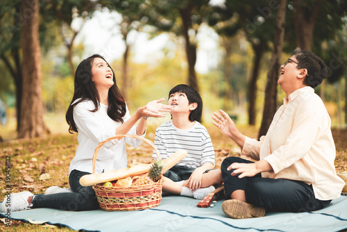Asian family having good time together in the park. © ztony1971