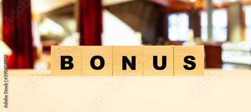 The word bonus in large letters on the dice. Business expression for homework.