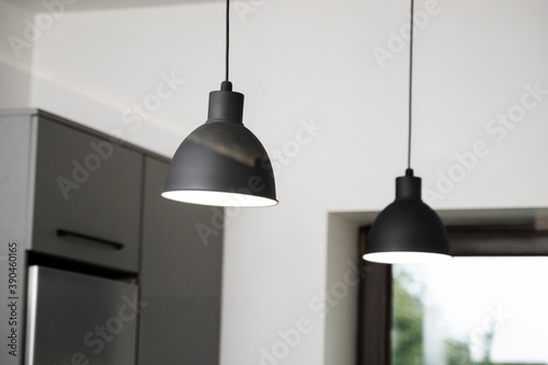 Obraz na plátně Industrial black look pendant lamps in a kitchen interior