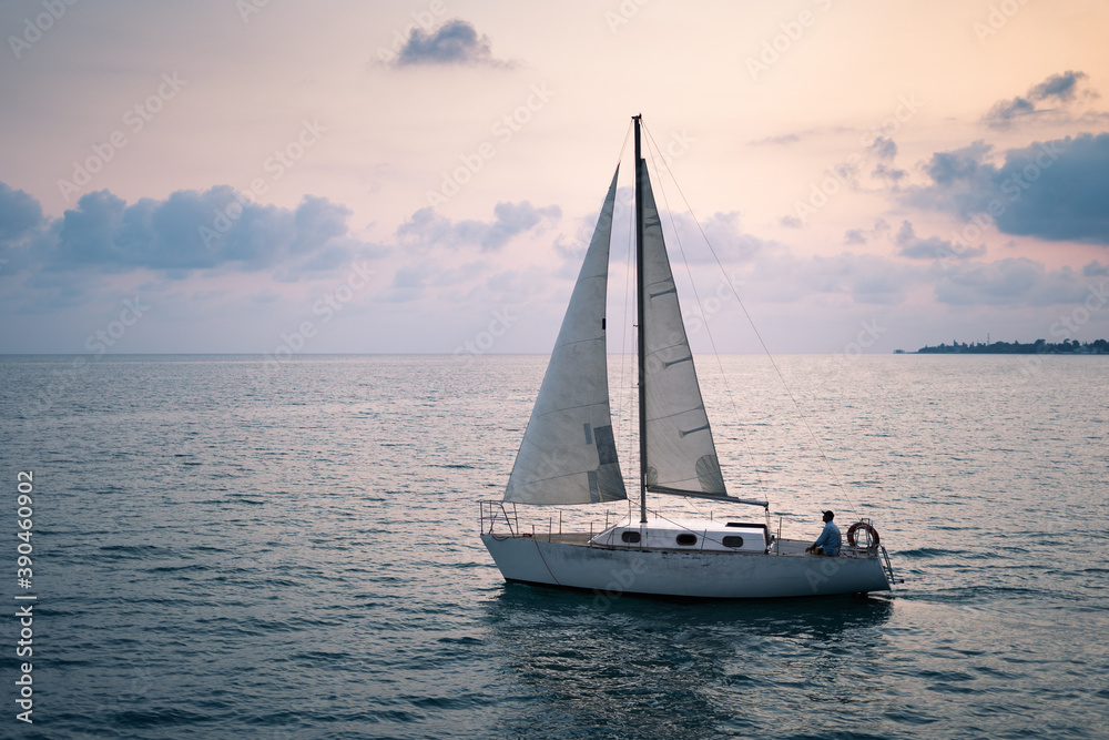Fototapeta premium Sailing boat in the sea at sunset