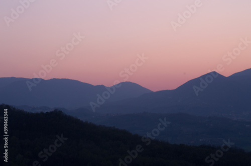 A pink sunset between the mountains.