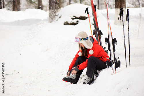 Getting ready for skiing, fastening the boots. photo