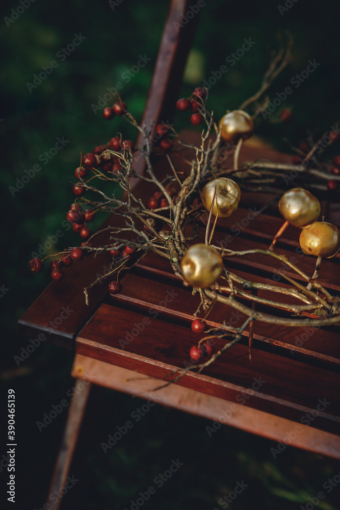 autumn wreath with thorns and apples on a wooden chair autumn wreath with thorns and apples on a wooden chair