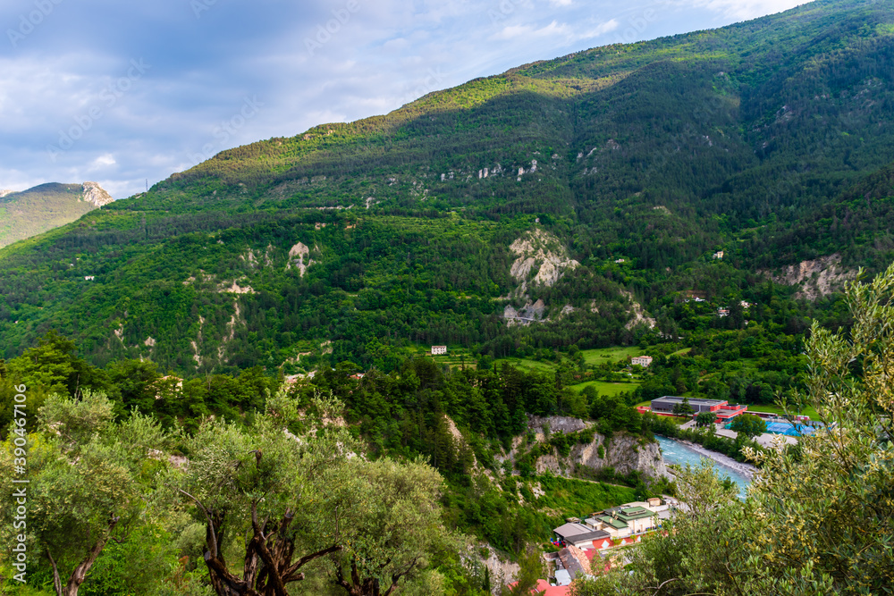 A picturesque panoramic view of a French alpine village Puget-Theniers in the valley of Var river (Provence, Alpes-Maritimes, France)