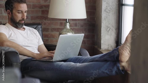 A man teleworks with the computer from his home