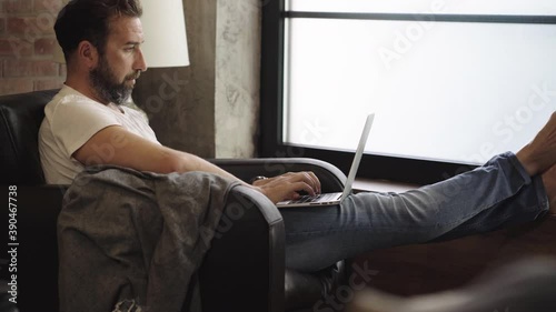 A man teleworks with the computer from his home