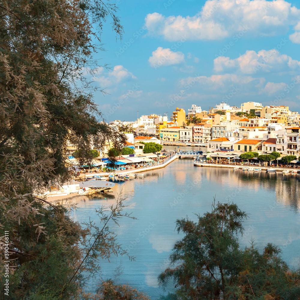 view from the hill to a quiet bay with boats in the Greek resort town of Agios Nikolaos