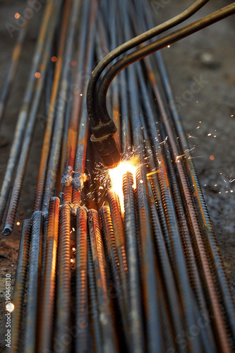 A person works with welding, sparks, close up, construction photo