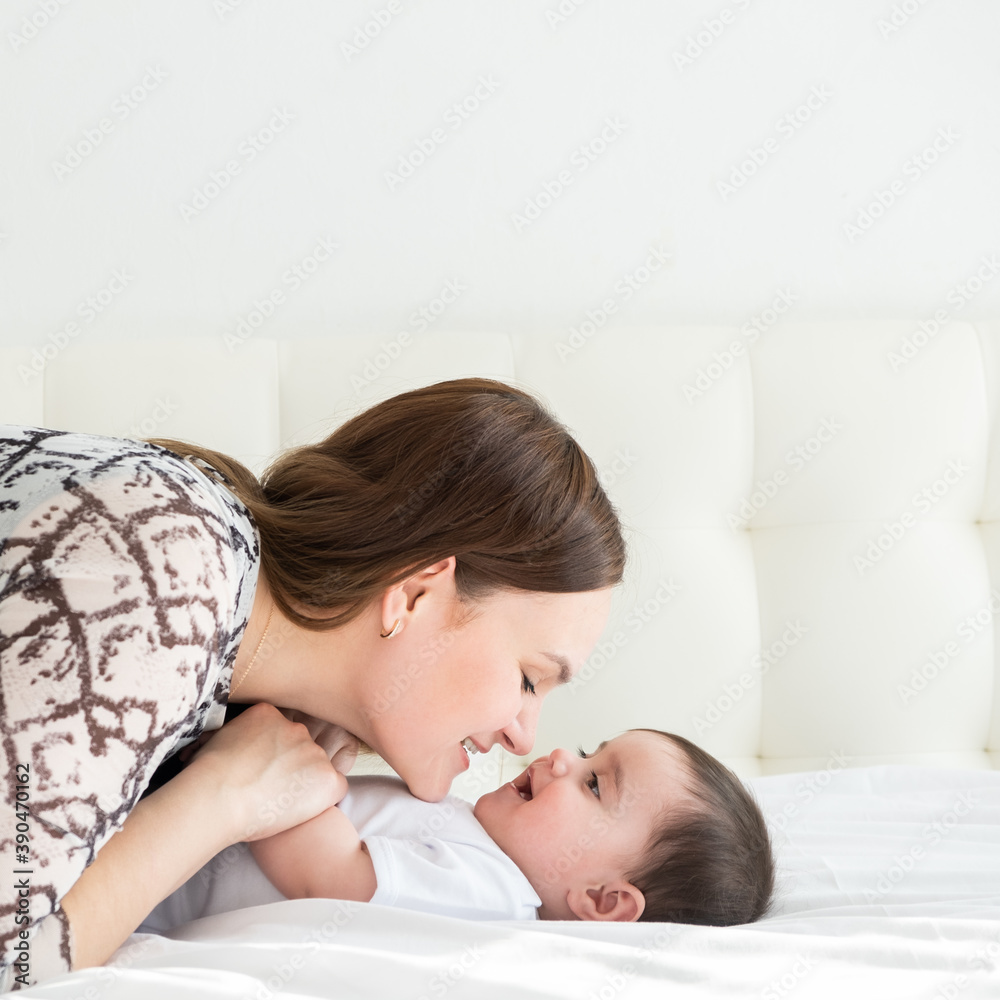 Happy young mother holding hands her little daughter in bed. love lifestyle mother's day concept. Happy young mother holding hands her little daughter in bed. love lifestyle mother's day concept.