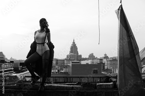 Photography Girl in a gas mask on the background of the city