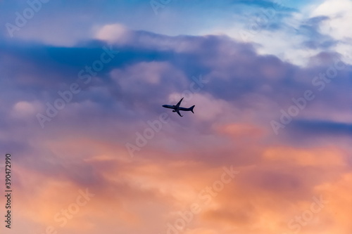 Airplane against the sky with clouds at sunset in summer  background  banner  Wallpaper  texture 