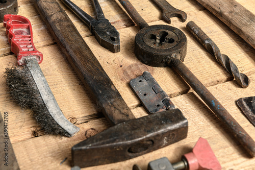 Variety of old vintage household hand tools still life on a wooden background in a DIY and repair concept